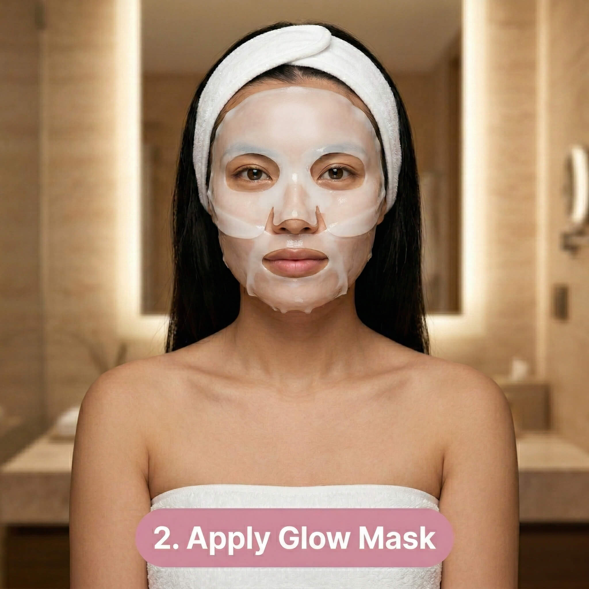 A woman wearing a white headband and towel applies a sheet mask to her face in a bathroom. Text at the bottom reads, 2. Apply Glow Mask.