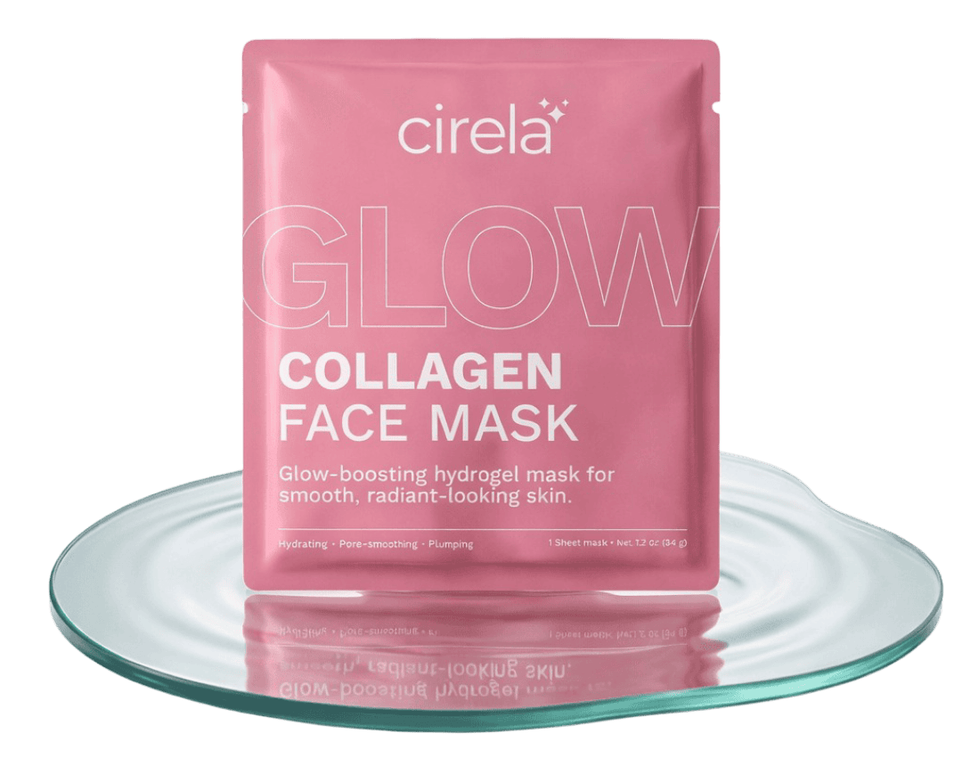 A pink packet of Cirela Collagen Face Mask sits on a clear, round glass tray. The packaging highlights its glow-boosting, hydrating, and pore-smoothing benefits for radiant-looking skin.