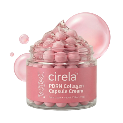 A glass jar of Cirela Beauty PDRN Collagen Capsule Cream with pink, capsule-shaped beads sits before two translucent pink bubbles, promising instant glow and even skin tone. Net weight: 1.76 oz (50g).