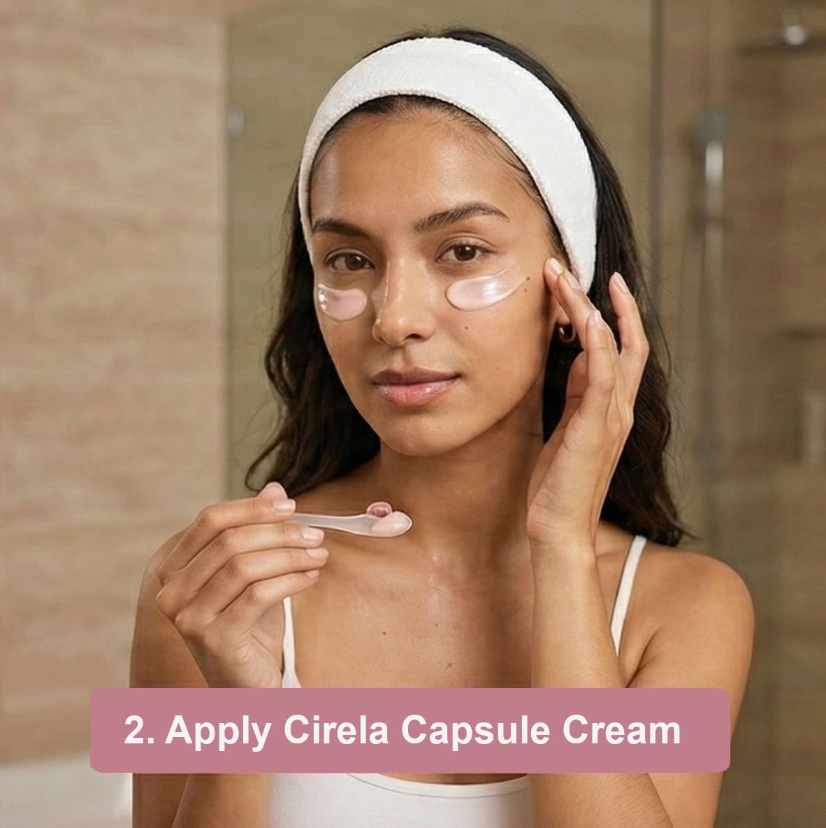 A woman wearing a white headband and tank top applies under-eye patches in a bathroom, holding a small spatula. Text at the bottom reads: 2. Apply Cirela Capsule Cream.