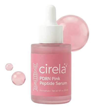 A pink bottle of Cirela Beauty PDRN Pink Peptide Serum with a white dropper cap features a DNA graphic on the label. Three translucent pink drops sit beside it, showcasing this glow-boosting peptide serum.